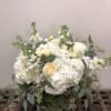 Assortment of all white flowers, pretty soft greenery in a low vase.

Flowers