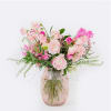 A delicate collection of sweet peas and ranunculus in mixed shades of