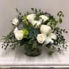 White lilies, roses, carnations with green buttons, assorted greenery and succulents arranged