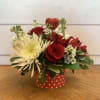 Red roses and a white cremon chrysanthemum stand out in this petite