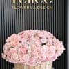 A full and romantic basket arrangement featuring premium blush pink roses and