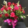 This beautiful arrangement make with red roses, hot pink carnations,  purple