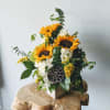 This beautiful arrangement is artfully designed in a birch container filled with