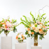 A soft yet striking collection of tall, airy floral arrangements in peach