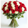 This arrangement features a large, dome-shaped bouquet of red and white roses