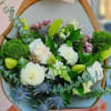 This bouquet has a fresh, elegant, garden-inspired feel with a soft, natural