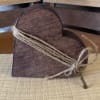 This charming wooden heart is wrapped in rustic twine and finished with