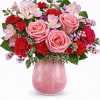 Pink &amp; Red Floral Arrangement in a Pink Glass Vase

This charming floral