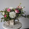 This beautiful arrangement is artfully designed in a birch container filled with