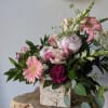 This beautiful arrangement is artfully designed in a birch container filled with