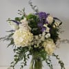 A beautiful garden feel arrangement of white and purple blooms! 