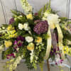 Sal's Serenity half casket display is brimming with beautiful blooms.  Abundant