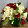 Spread the holiday cheer with this beautiful centerpiece. Designed low and compact