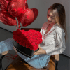 An iconic luxury arrangement featuring a heart-shaped box filled with velvety red