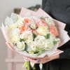 This exquisite hand-tied bouquet is a stunning celebration of elegance and charm