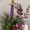 An elegant, garden-inspired arrangement designed with graceful height and rich texture. Featuring
