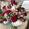 Beautiful arrangement of rich deep red roses, tulips, lilies, hydrangea and stock