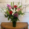 Red and pink roses with pink snapdragons, fragrant white stock, green bells