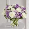 Beautiful combination of lavender flowers and white arranged in a glass cylinder