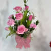 This keepsake pink, ceramic, bow vase holds a fresh, fanciful bouquet of