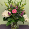 Power to the flowers! This gorgeous floral bouquet features an abundance of