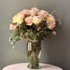 A soft, romantic arrangement featuring creamy white roses and delicate pink roses