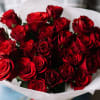 12 beautiful red roses are artfully arranged in this handcrafted bouquet and