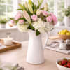 A romantic blend of hydrangea, delicate spray roses, 