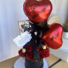Red roses in a box with hearts and chocolates