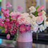 A lush, romantic arrangement featuring premium garden roses, spray roses and seasonal