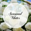 A variety of white seasonal flowers ***flowers and vase will vary***