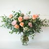 Long Roses in a traditional clear vase. Peach and Pink. 
