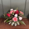 A sweet and romantic Valentine's arrangement featuring vibrant red and soft pink