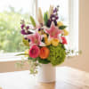 A sensory delight with flowers like yellow roses, stargazers, and green hydrangea
