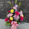 Tall, garden-style bouquet with a cheerful, uplifting feel. It features a vibrant