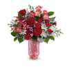 Beautiful arrangement with pink vase, pink alstro, red roses, and white pom