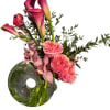 Pink calla lilies, pink garden roses, and pink cymbidium orchids come together