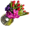 Red tulips, hot pink Vanda orchids, and purple anemones create a striking
