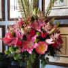 Elegant large pedestal vase filled with magnificent oriental pink lilies, hot pink