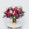 A romantic seasonal Valentine&rsquo;s Day arrangement featuring lush red and blush roses