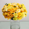 This bright, golden pav&eacute; of Roses and Spray Roses rests atop a