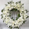 This Wreath offers peaceful wishes of heartfelt sympathy with each delicate bloom.