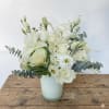 This white and green arrangement includes white hydrangeas, green hydrangeas, white roses