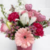A romantic arrangement of soft pink blooms and delicate accents, thoughtfully designed