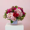 Our exclusive arrangement featuring the perfect blend of beautiful blush and pink