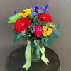 Vase of bright gerbera, fugi mums, iris, button mums, spray roses and