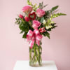 3 roses surrounded by seasonal fresh flowers in soft shades of pink