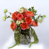 Bursting with vibrant charm, this bouquet of coral garden roses and soft