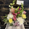 This arrangement features a soft, comforting mix of fresh blooms in gentle