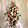 Orange roses, pink carnations, white mums, daisies, and greens